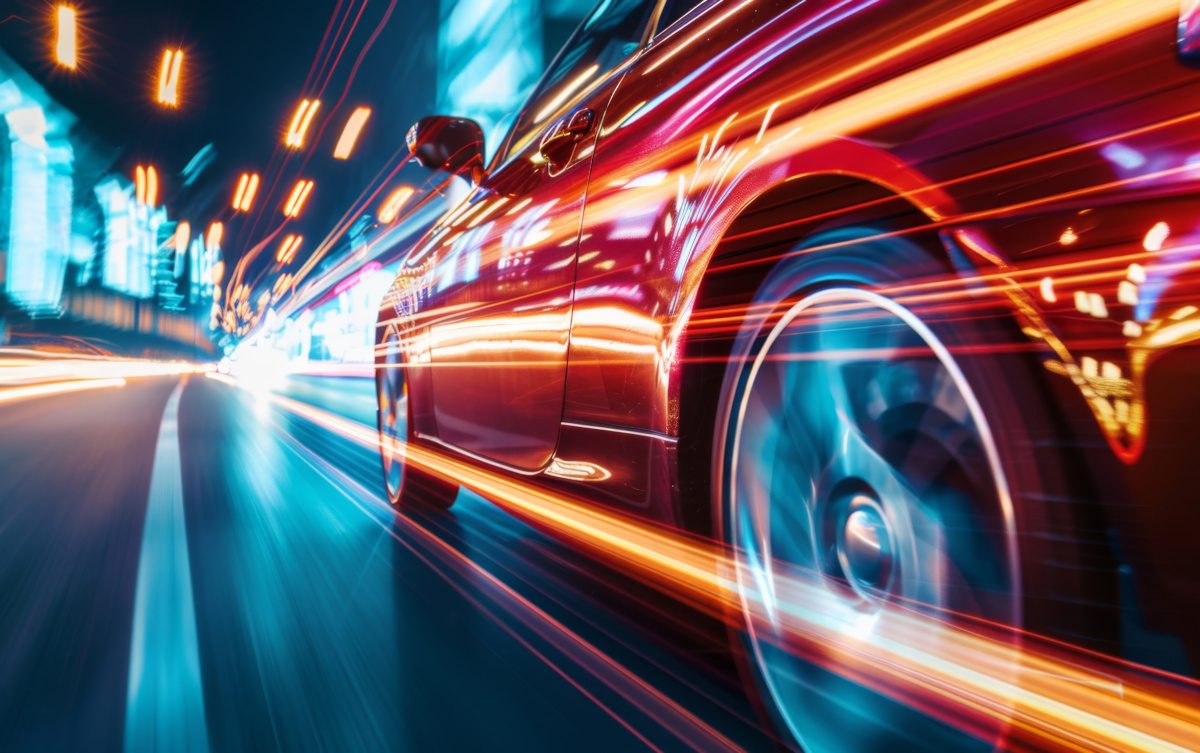 Rear view of Futuristic Car with high fast and speed through neon mega cyber city background, High acceleration car on tack with glowing light trails, night scene neon.